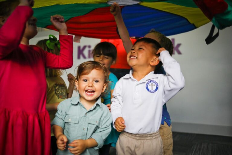 Photo Kindermusik MadelineThibodeauxStudio 2018 children smiling parachute Level4 2520x1680 1024x683 1 768x512